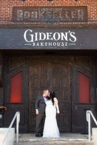 photography of wedding couple in front of gideon's bakehouse at disney springs