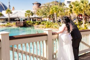 photo of wedding couple looking at the water at disney springs