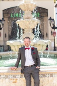 photography of groom in front of a fountain after getting married at disney springs