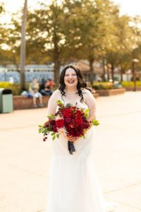 photography of bride in the sunshine holding wedding bouquet at disney springs