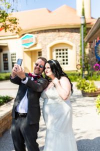 photo of couple taking a selfie after their wedding at disney springs
