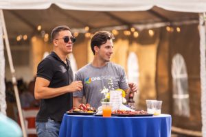 two men at a standing table at golden hour at a corporate event in orlando