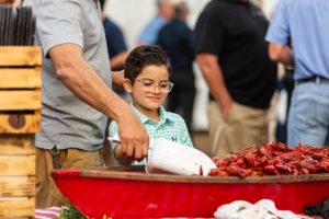 child getting crawfish at a corporate party at the acre in orlando