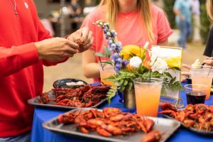 picture of hands eating crawfish at a corporate party in orlando