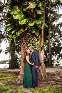 couple in front of a cypress tree at kraft azalea garden in winter park