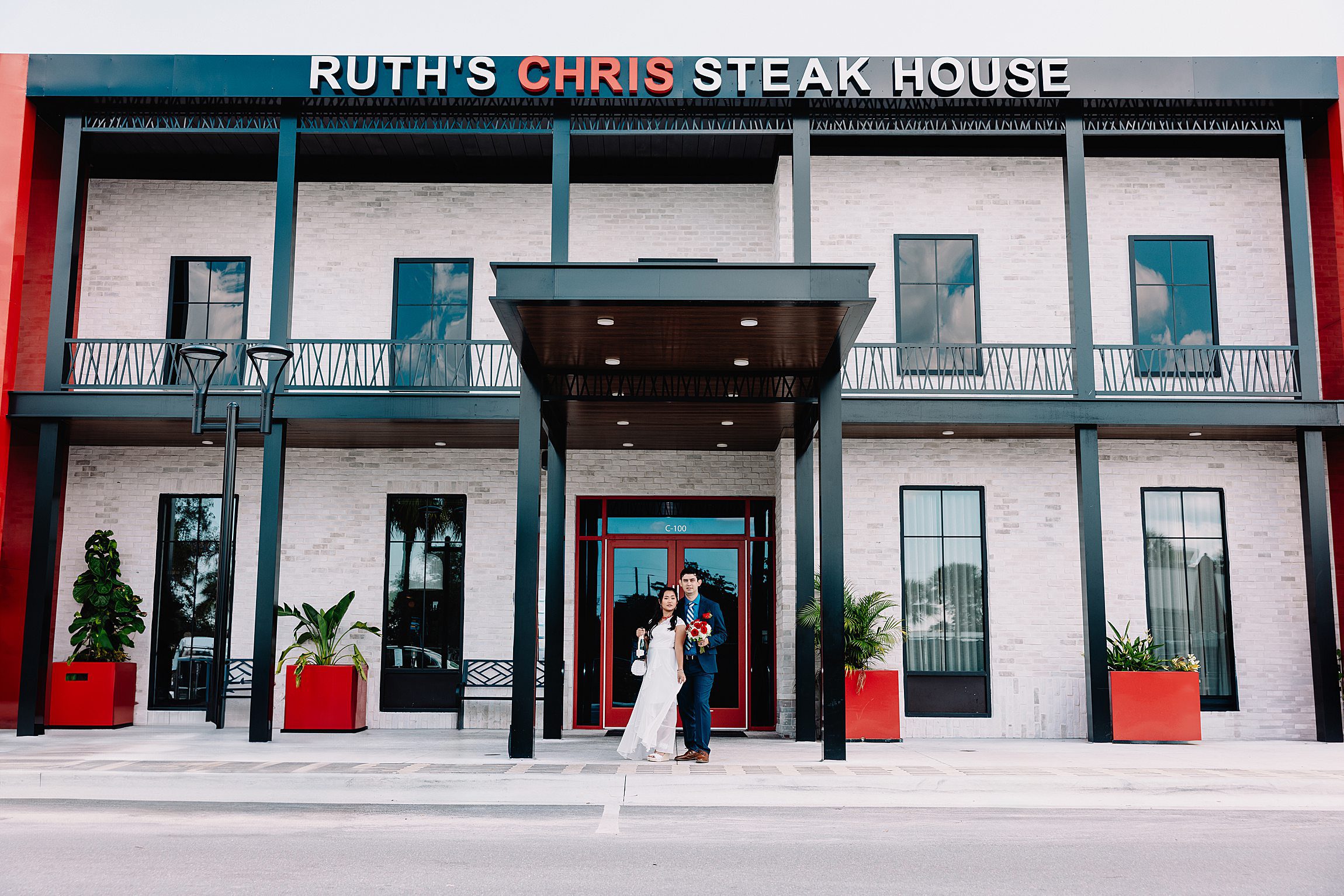 couple standing outside ruth's chris steakhouse in winter park after their courthouse wedding in downtown orlando