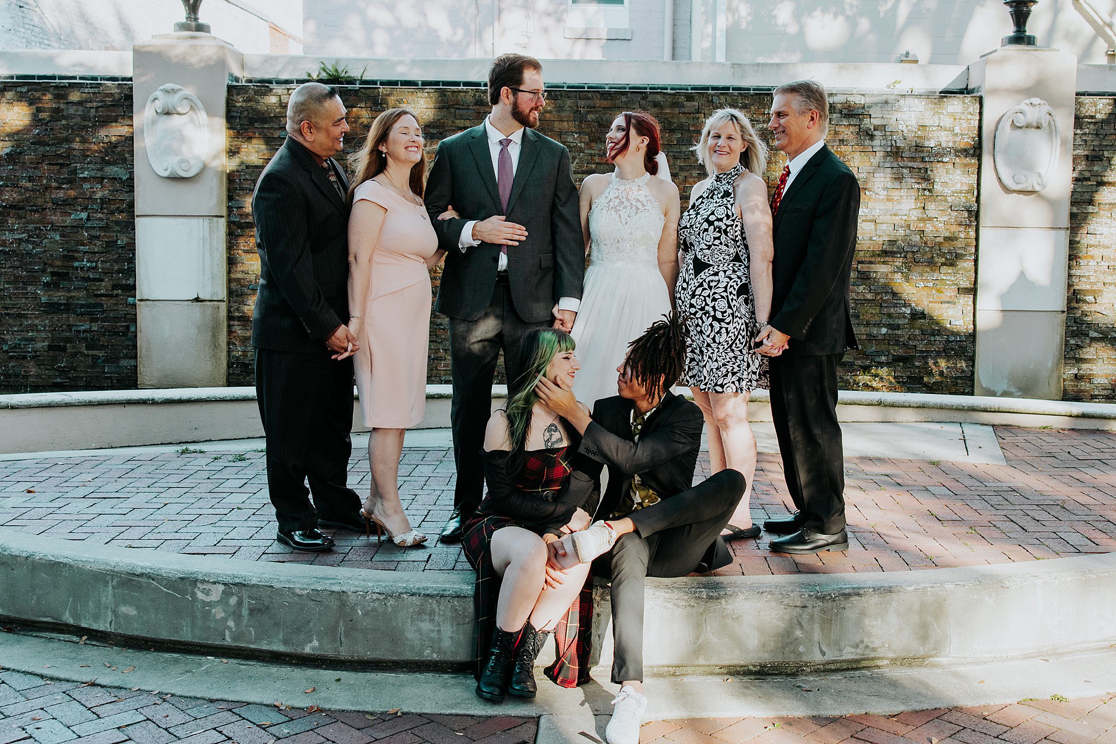 family taking photos in chess park after a volusia county courthouse wedding