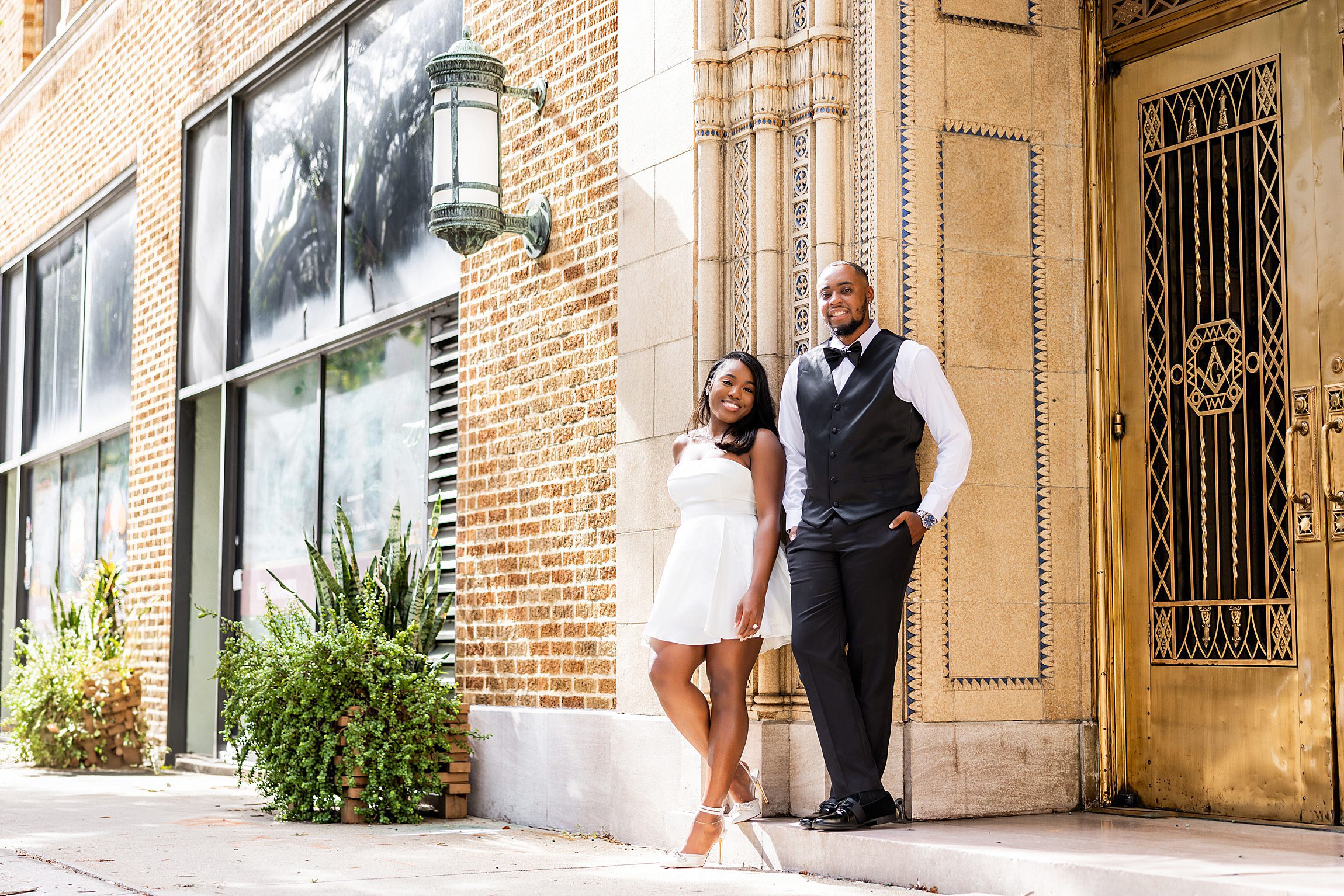 black couple pose outside the masonic lodge in downtown tampa after their courthouse wedding