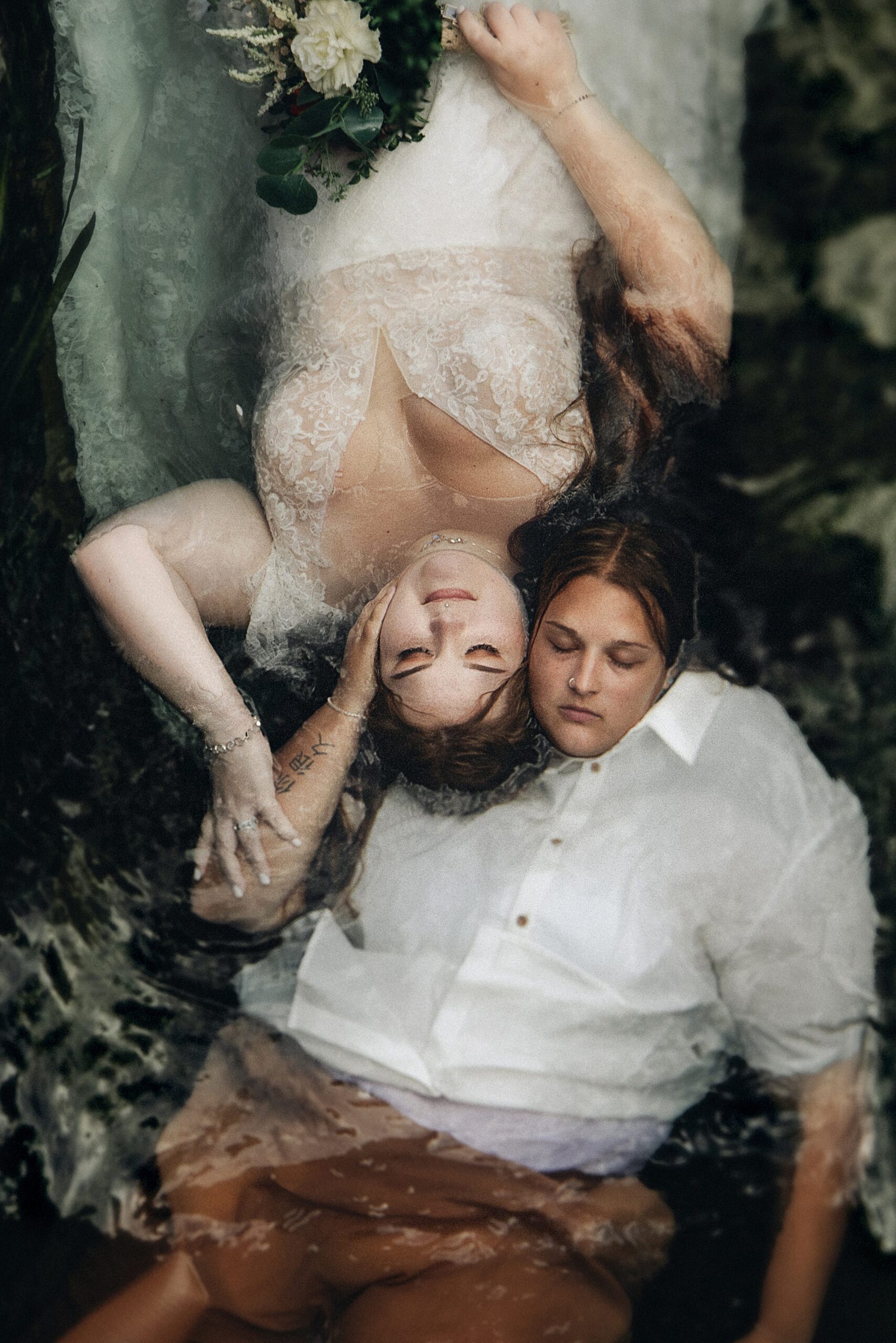 aerial shot of couple floating in a river
