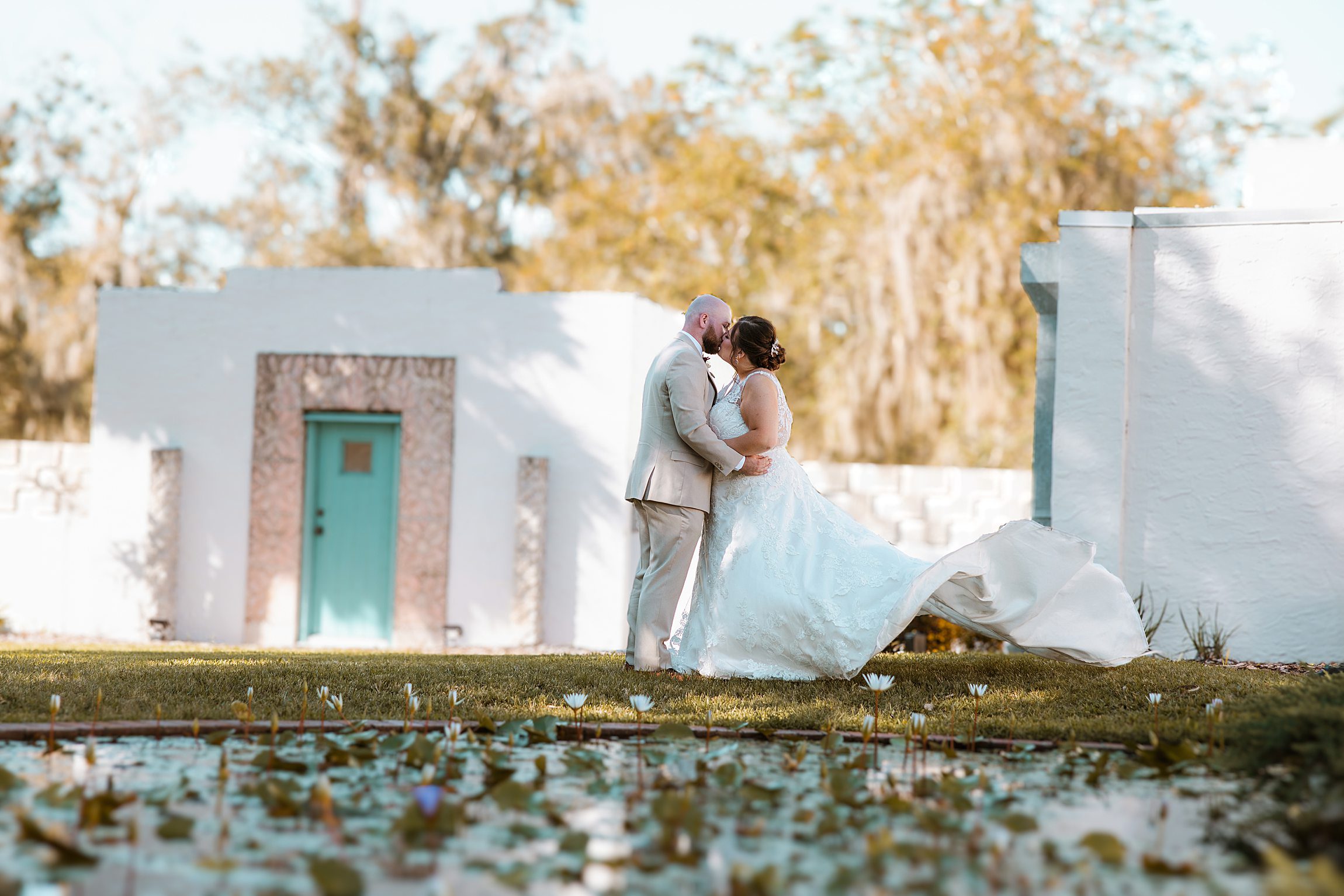 straight couple kisses at the waterlilies pond after their Micro Wedding at the Maitland Art & History Museum