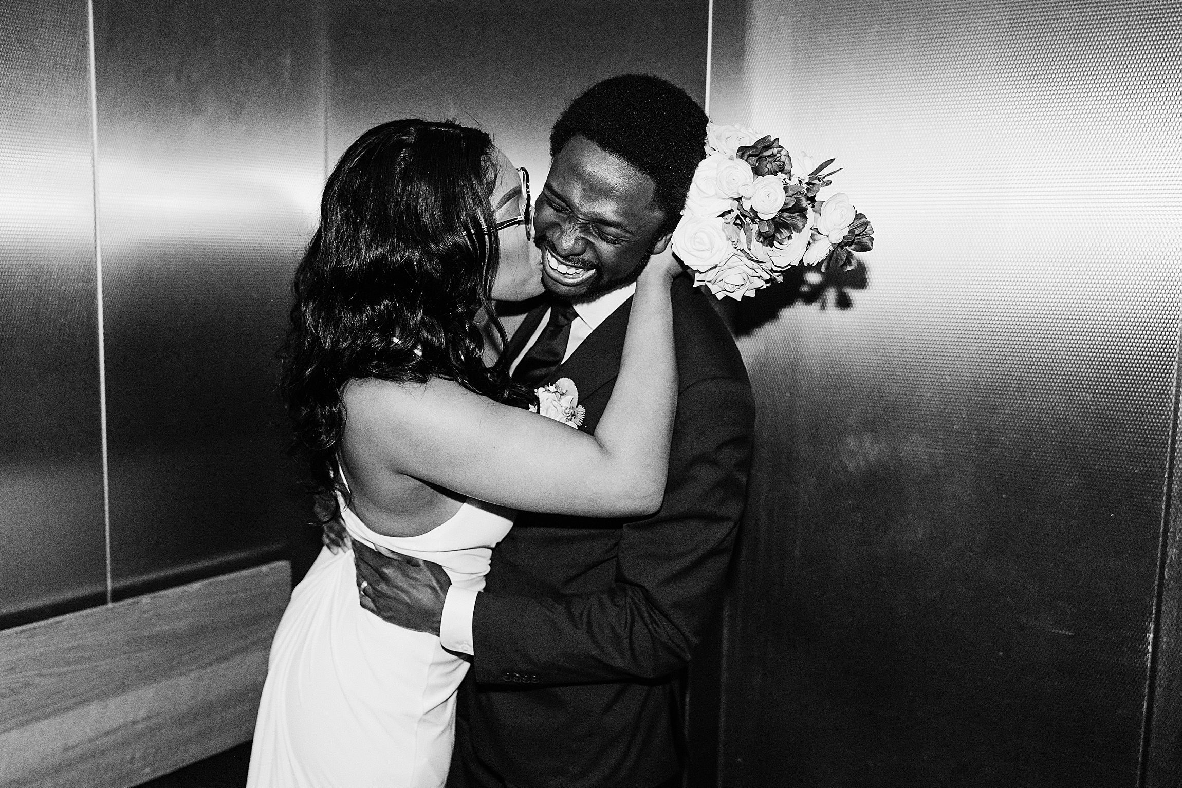 couple in elevator after their elopement at the courthouse in downtown orlando