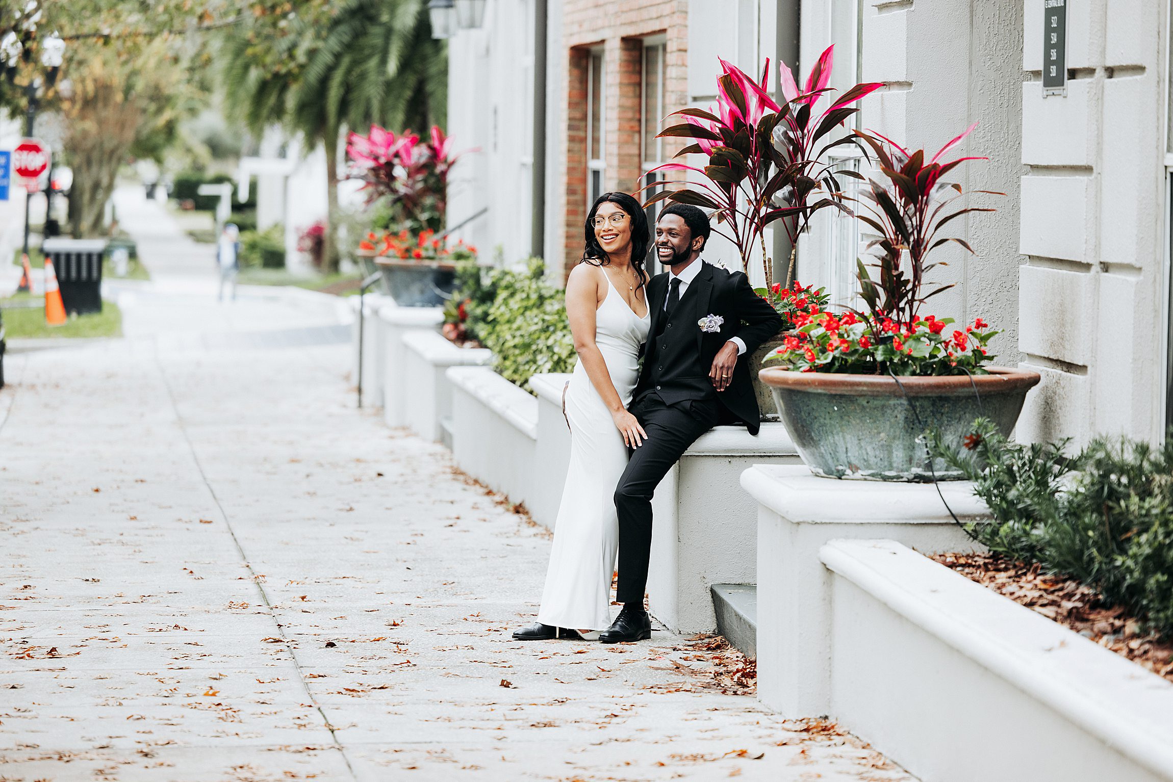 couple poses on a residential street in thornton park orlando