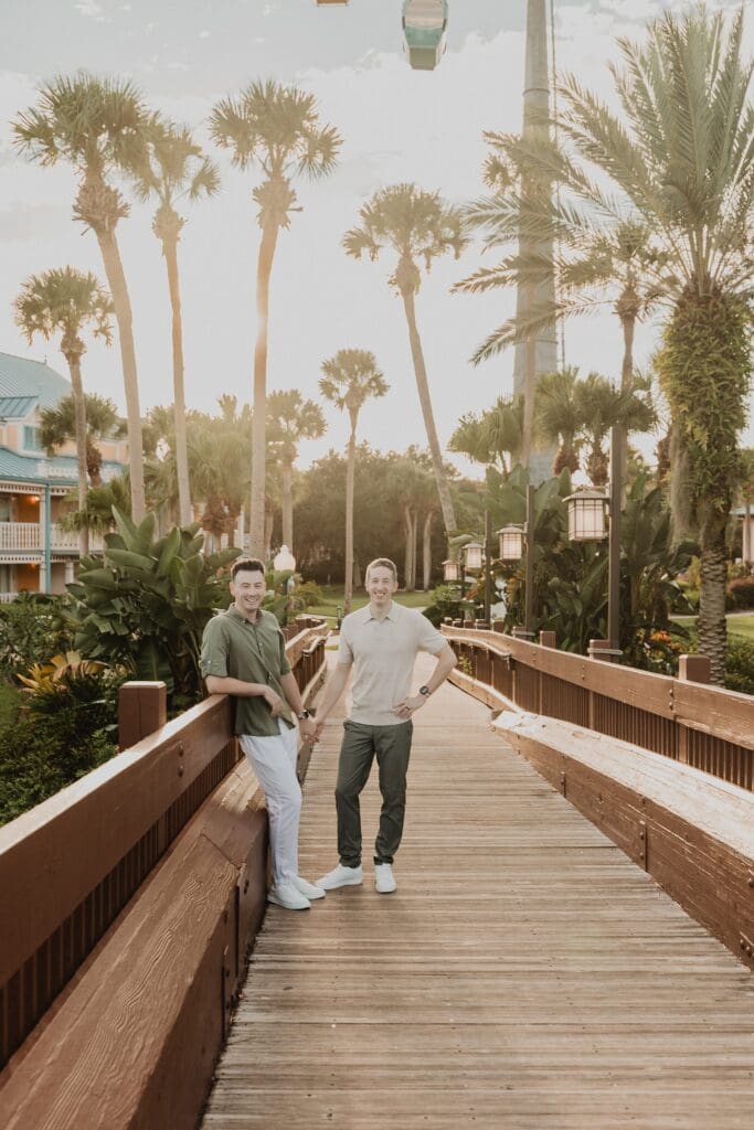 LGBTQIA+ elopement portrait of two grooms wearing casual tan and brown outfits on a boardwalk at an Orlando Florida resort, captured by Gracie May Photography