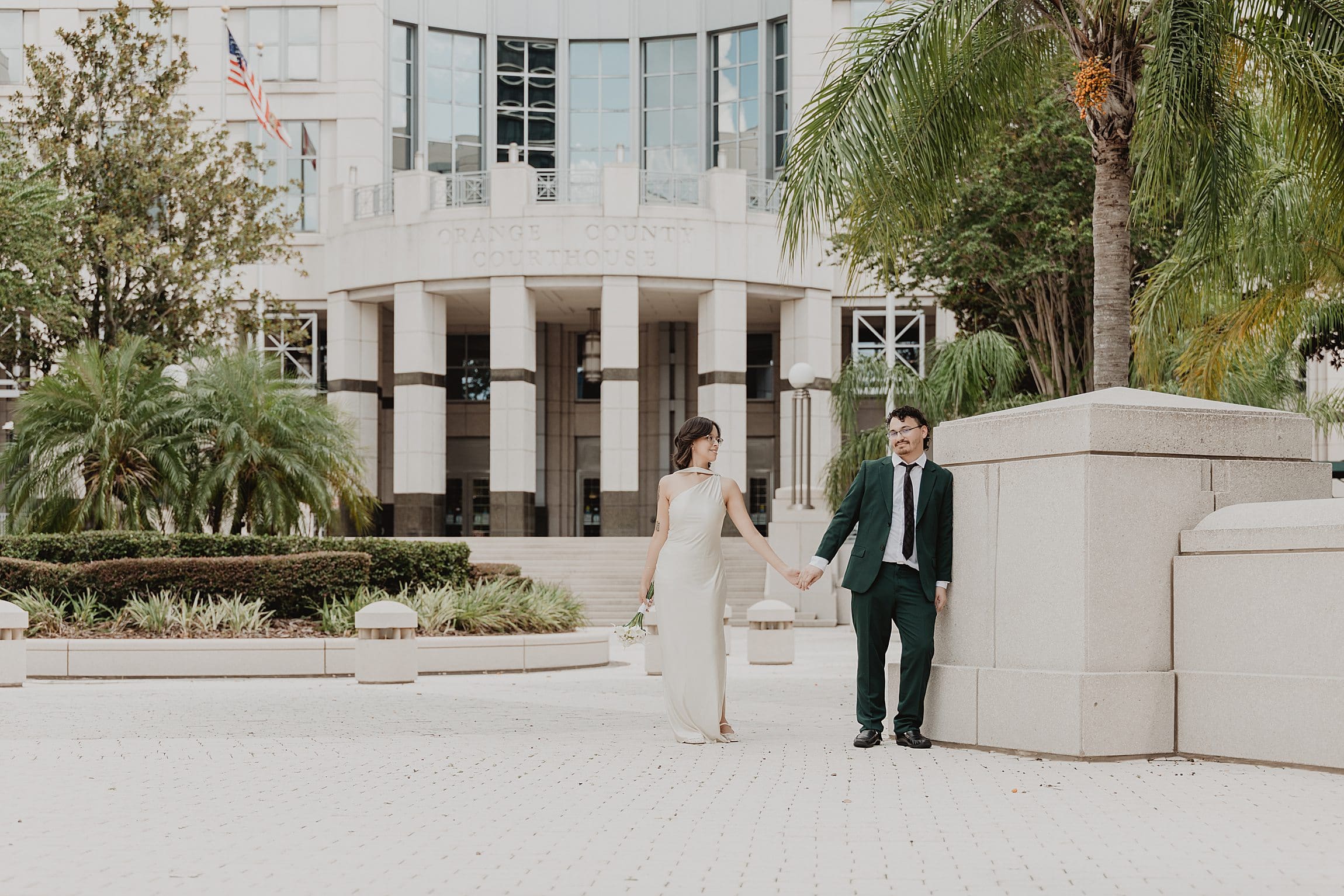 newly married couple outside the orange county courthouse in downtown orlando after their wedding