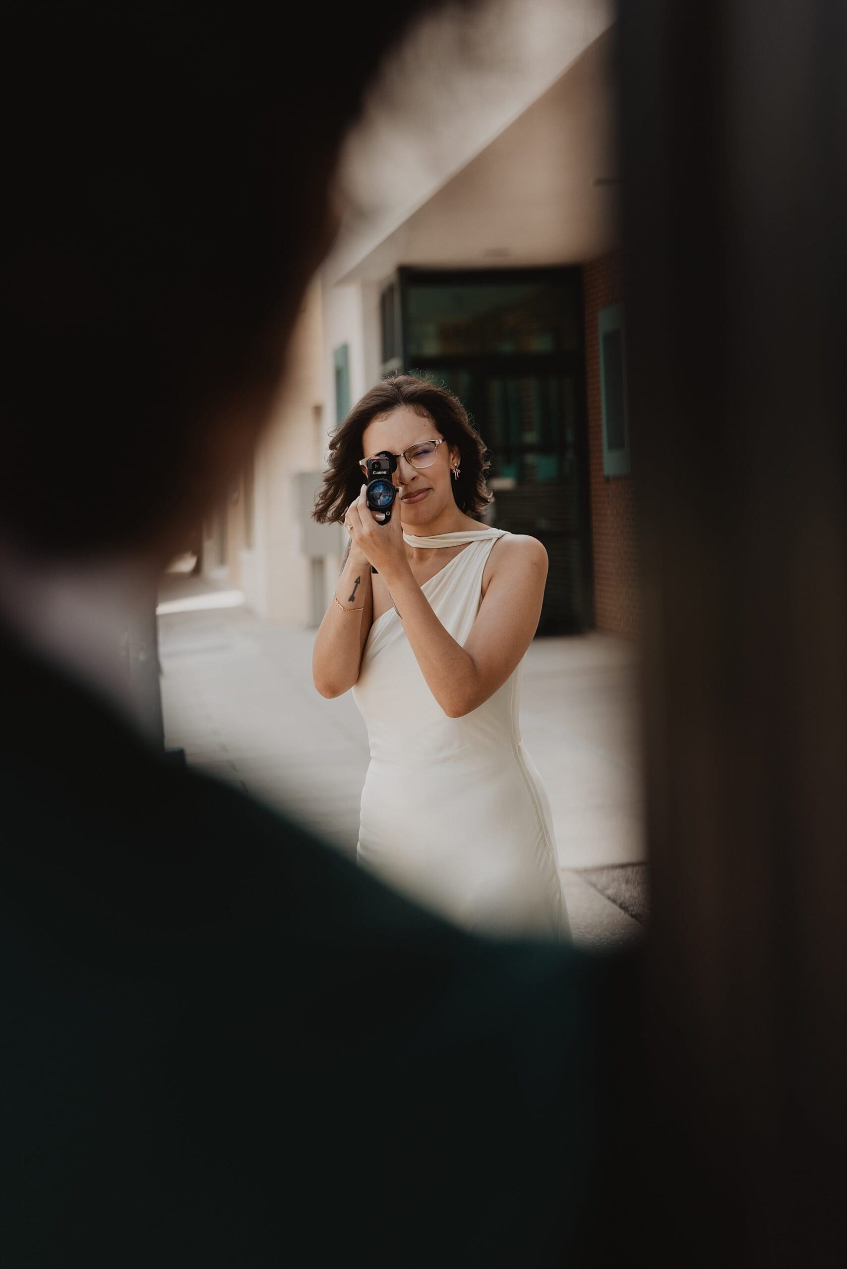 bride in orlando using a super 8 camera to film her groom