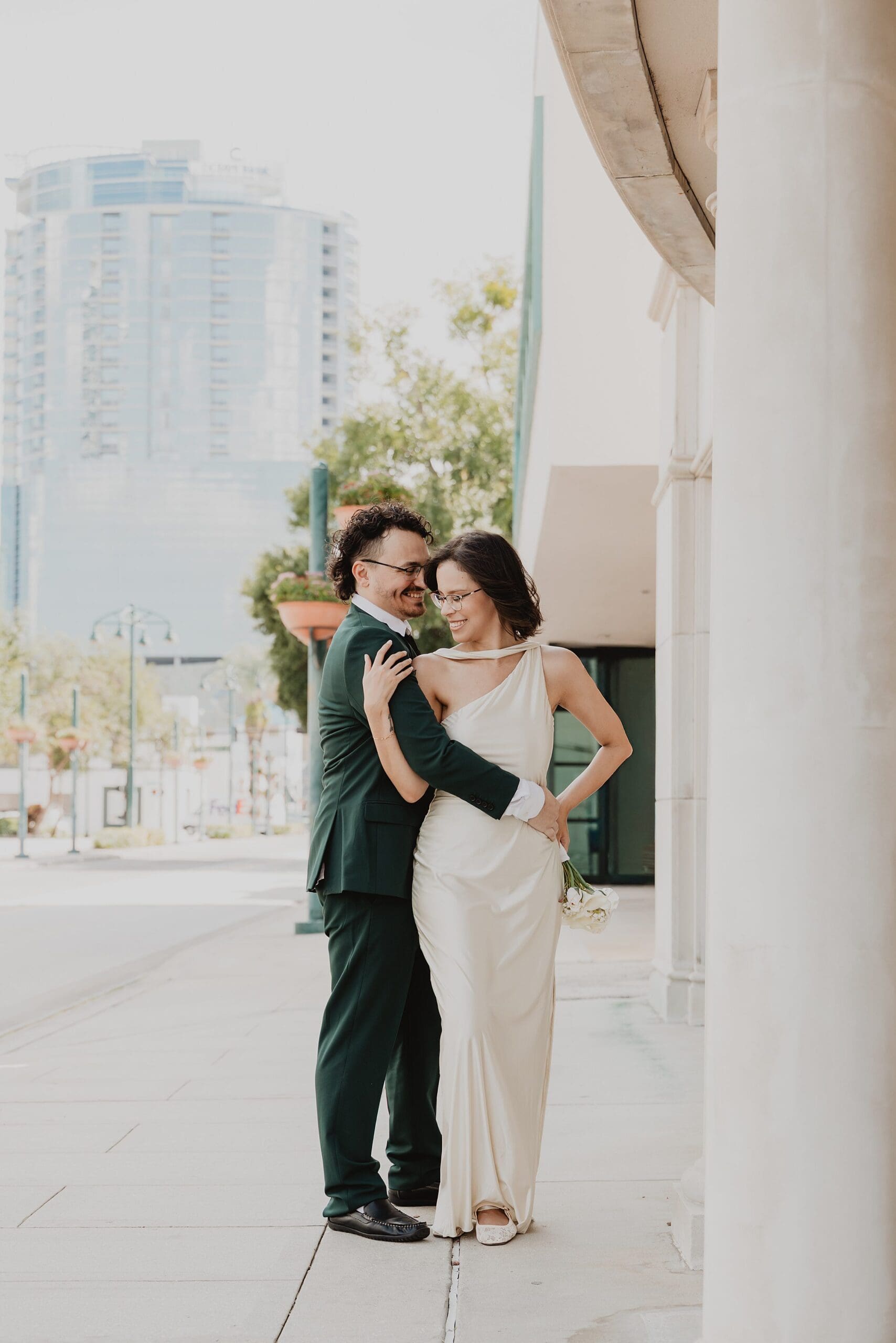 newly married couple in downtown orlando near the orange county courthouse after their civil ceremony wedding