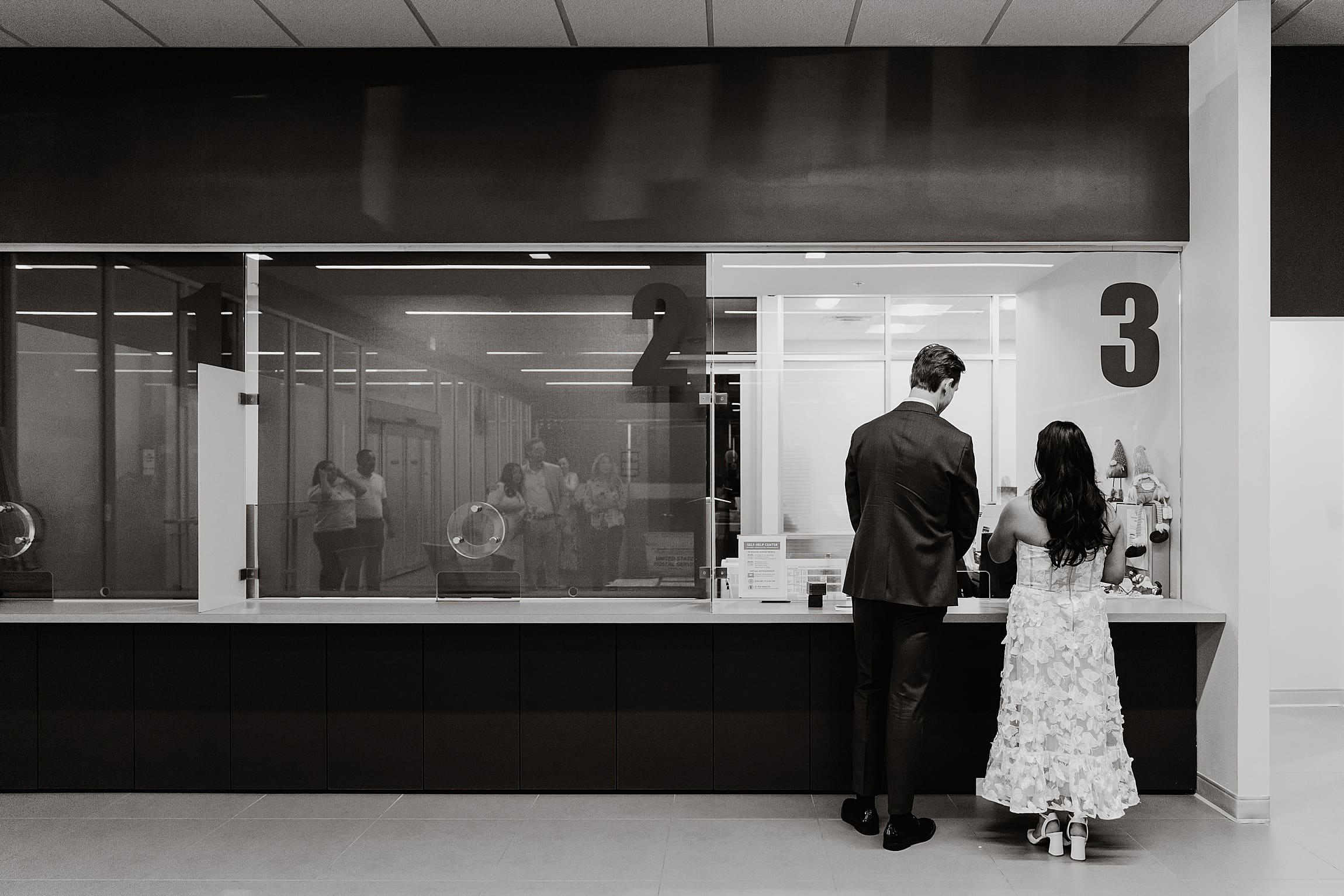Jacob and Arely raising their hands to be sworn in for their marriage at the Winter Park Clerk of Courts. A candid, authentic moment captured during a spontaneous Florida courthouse elopement.