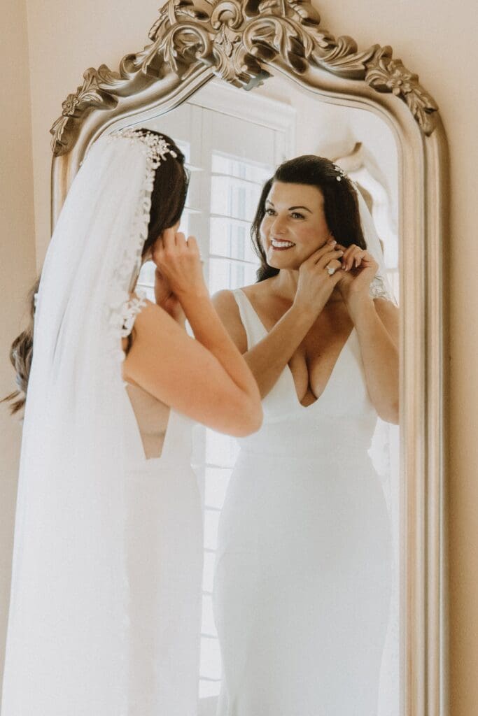 bride getting dressed for her backyard wedding in Mount Dora, Florida, captured by microwedding photographer Gracie May Photography