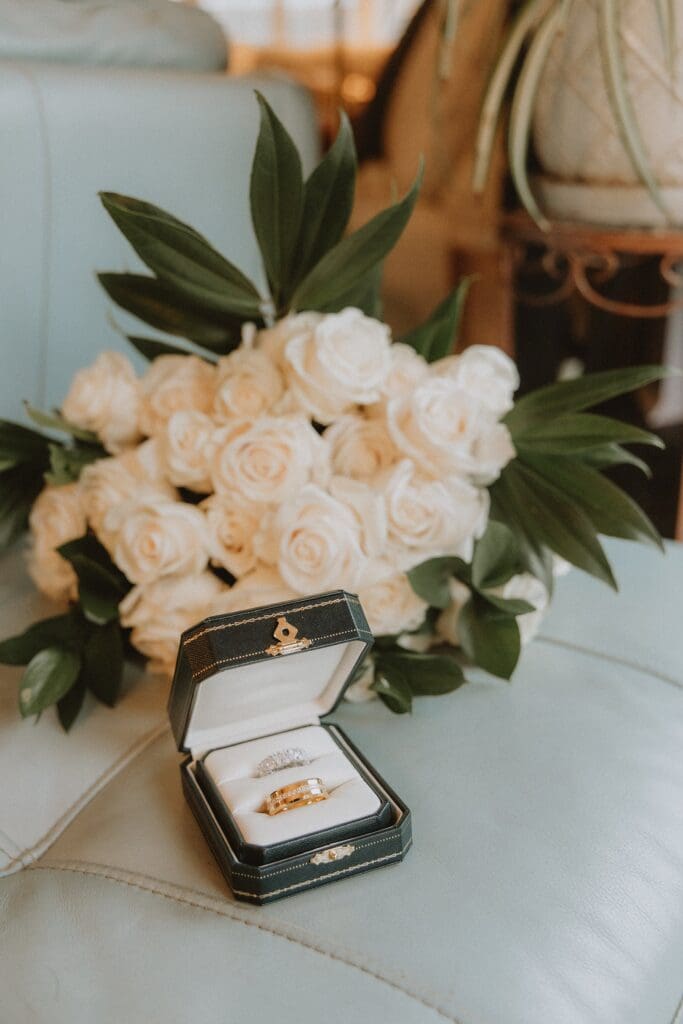 wedding rings and white rose bridal bouquet from a backyard wedding in Mount Dora, Florida, captured by microwedding photographer Gracie May Photography