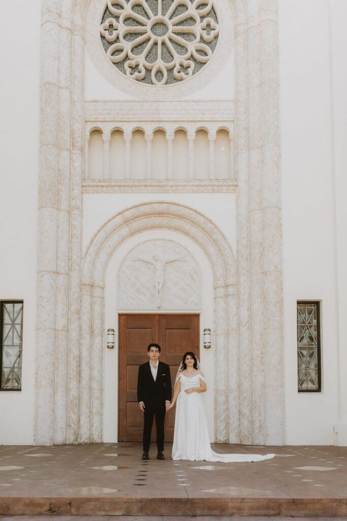 bride and groom pose outside of St. James Cathedral in Orlando after their micro wedding ceremony captured by Gracie May Photography