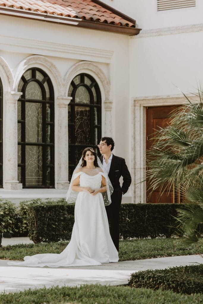 bride and groom pose outside of St. James Cathedral in Orlando after their micro wedding ceremony captured by Gracie May Photography