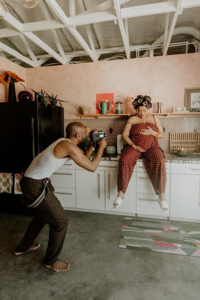 pregnant woman and man posing naturally and candidly during their retro lavender pregnancy maternity photoshoot captured by Gracie May Photography