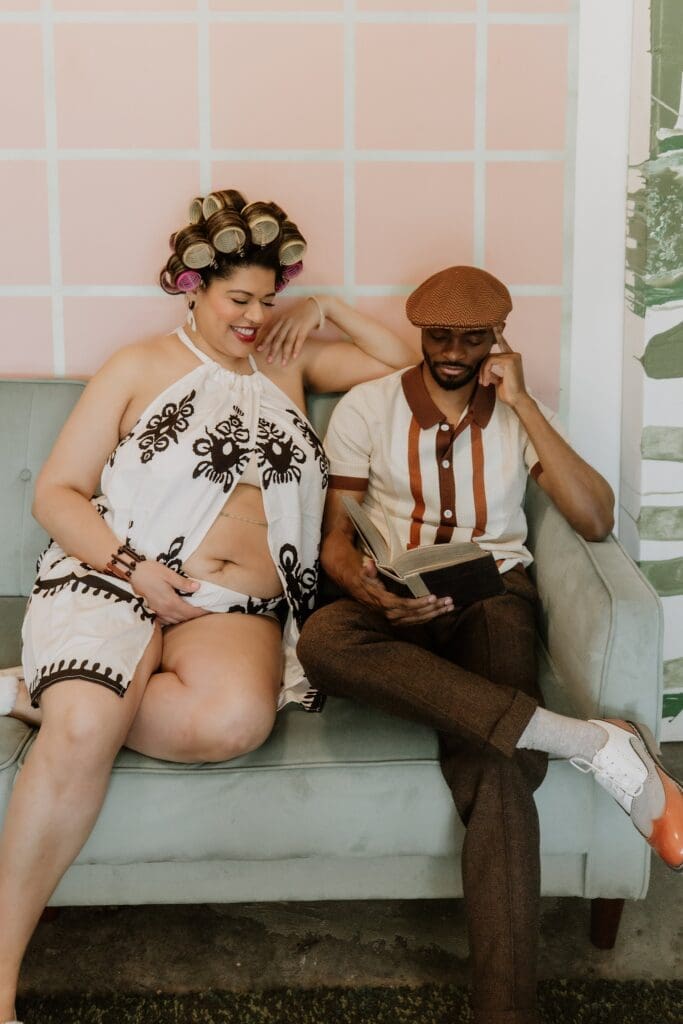 pregnant woman and man posing naturally and candidly during their retro lavender pregnancy maternity photoshoot captured by Gracie May Photography