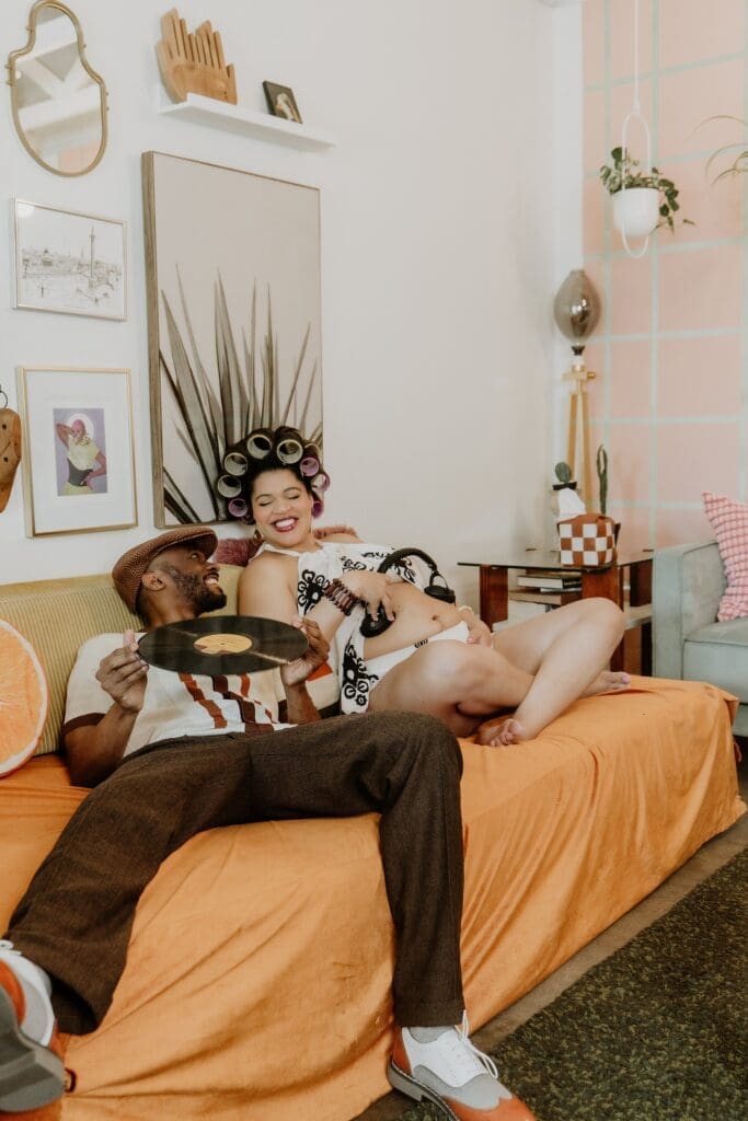 pregnant woman and man posing naturally and candidly during their retro lavender pregnancy maternity photoshoot captured by Gracie May Photography