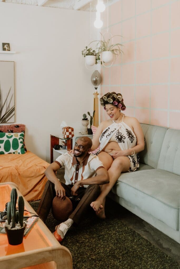 pregnant woman and man posing naturally and candidly during their retro lavender pregnancy maternity photoshoot captured by Gracie May Photography