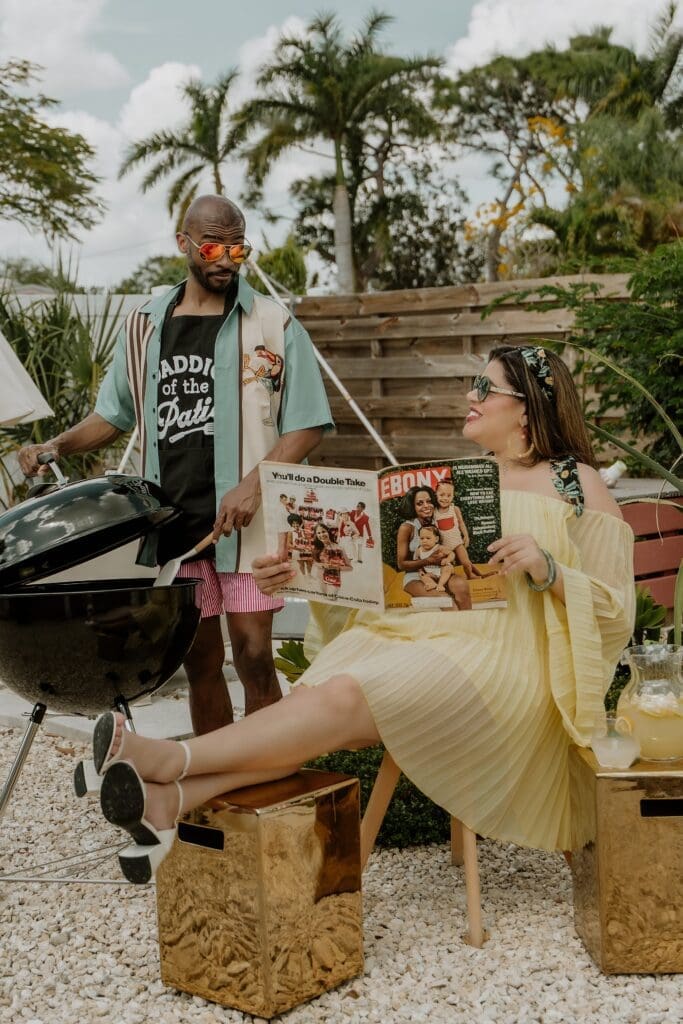 pregnant woman and man posing holding an Ebony Magazine during their retro lavender pregnancy maternity photoshoot captured by Gracie May Photography