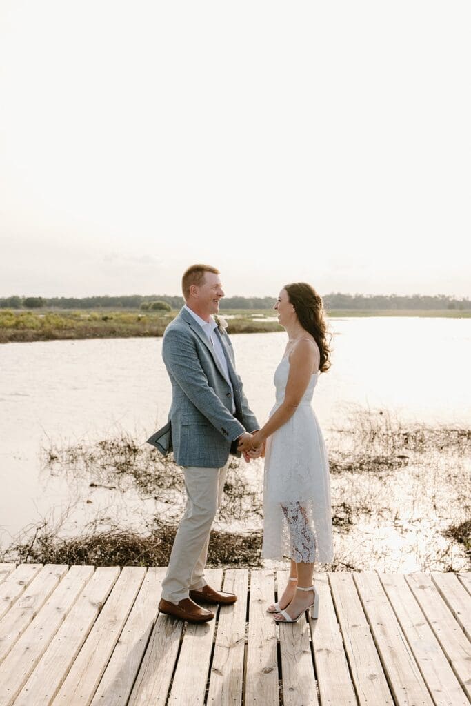 bride and groom on the dock at Lavender on the Lake in St Cloud, Florida, during their micro wedding ceremony captured by Gracie May Photography