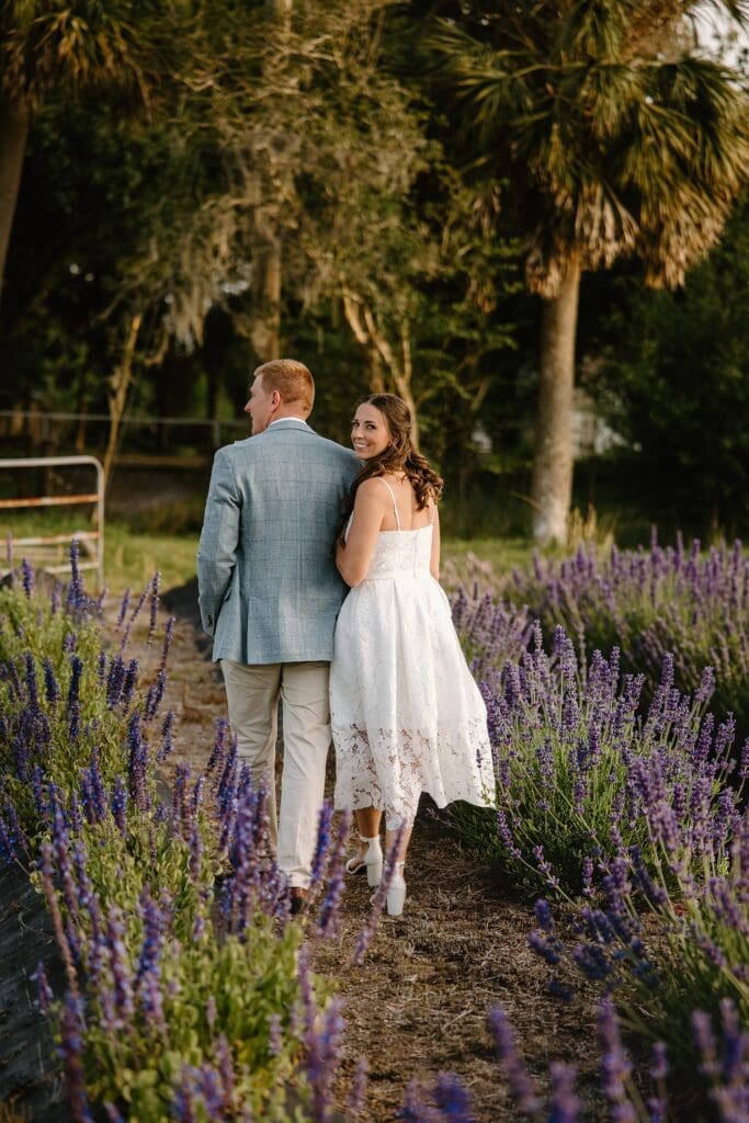 bride and groom in the lavender fields at Lavender on the Lake in St Cloud, Florida, during their micro wedding captured by Gracie May Photography