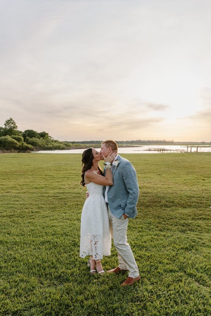 bride and groom kissing on the lawn at Lavender on the Lake in St Cloud, Florida, during their micro wedding captured by Gracie May Photography
