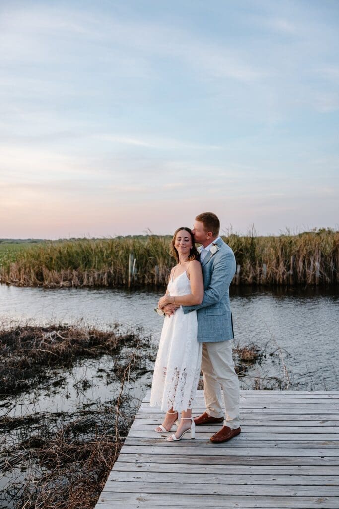 bride and groom on the dock at Lavender on the Lake in St Cloud, Florida, during their micro wedding  captured by Gracie May Photography