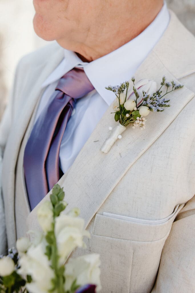groom portrait with a lavender boutenniere during a wedding ceremony at Sumter County Clerk's Office in the Villages Florida, captured by Gracie May Photography
