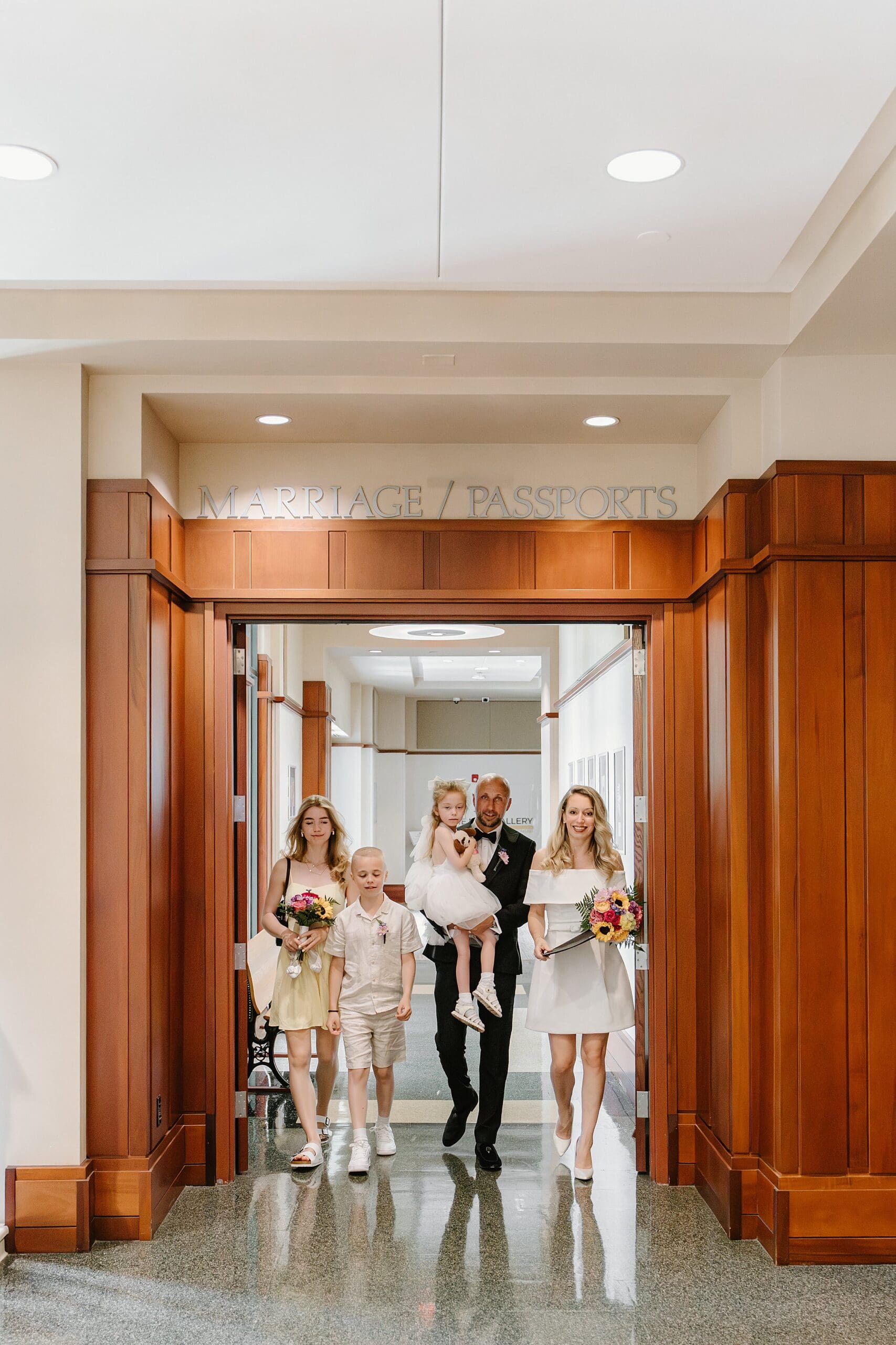 portrait of a couple with their kids inside the Osceola Country Courthouse for their courthouse wedding, captured by Gracie May Photography.