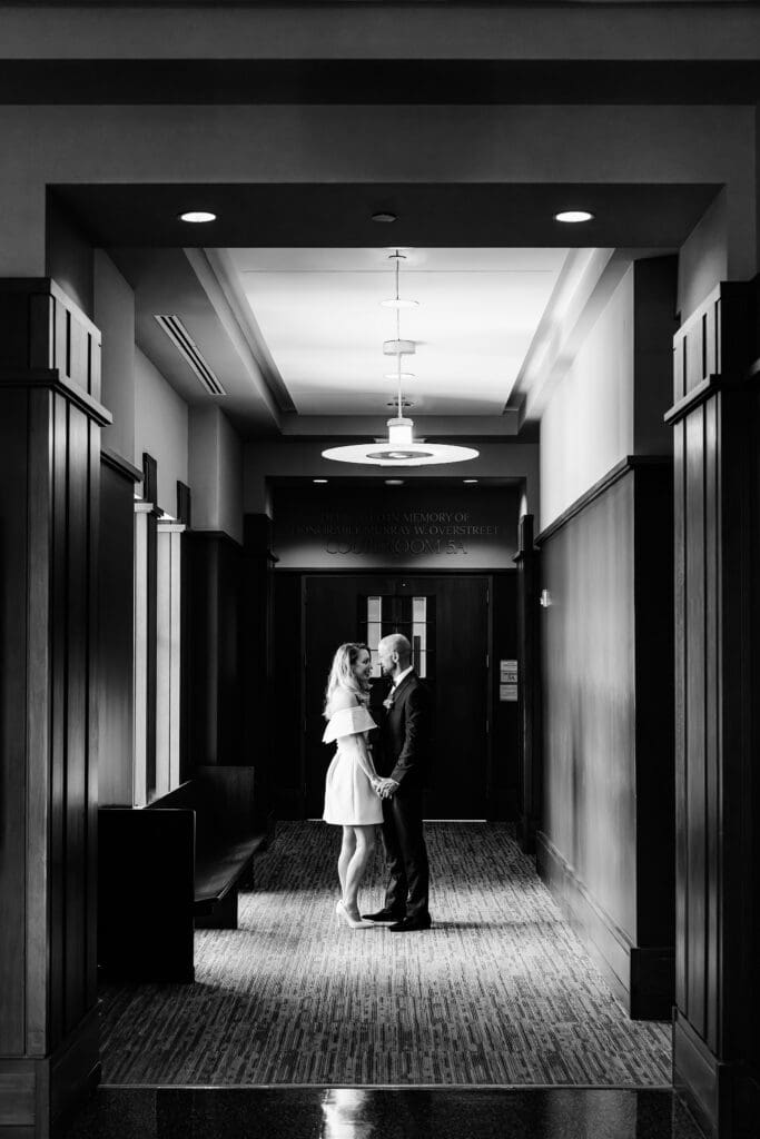 black and white portrait of a couple  inside the Osceola Country Courthouse for their courthouse wedding, captured by Gracie May Photography.