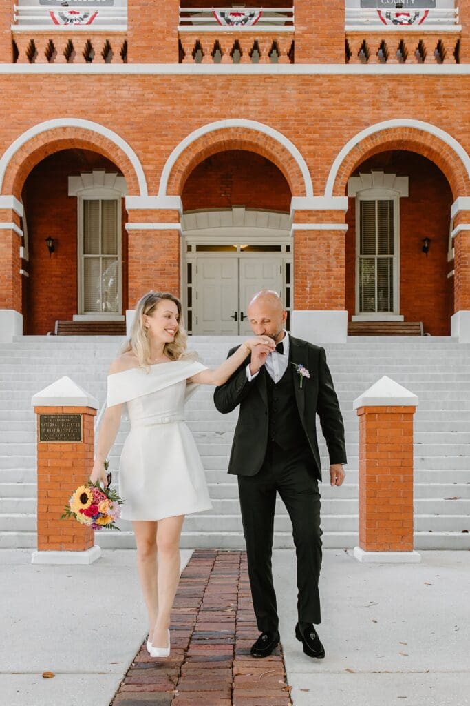 outdoor portrait of a couple outside of the Osceola Country Courthouse for their courthouse wedding, captured by Gracie May Photography.
