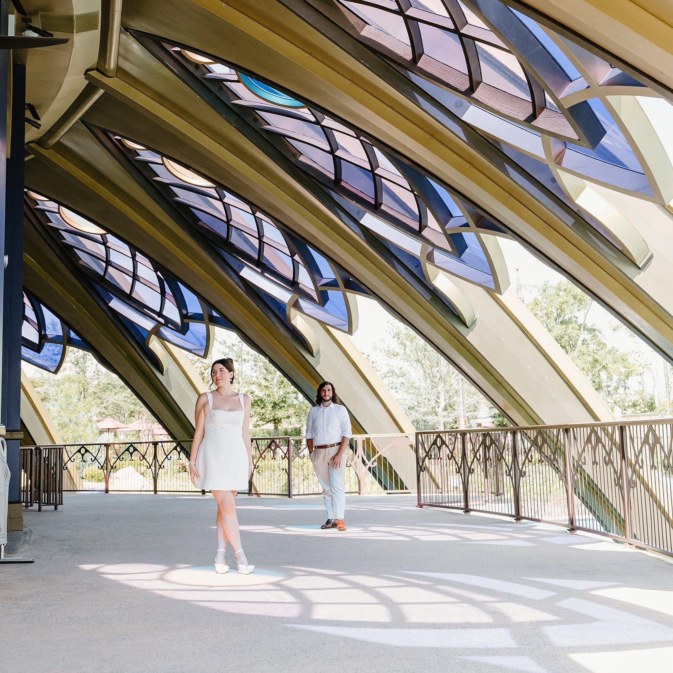 couple inside of the carousel at epic universe, highlighting the beautiful architecture