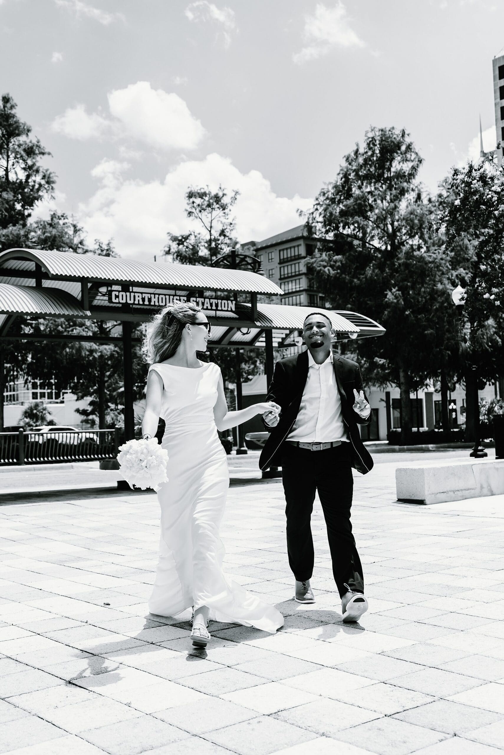 black and white editorial image of a bride and groom during their wedding at the orange county courthouse in downtown Orlando