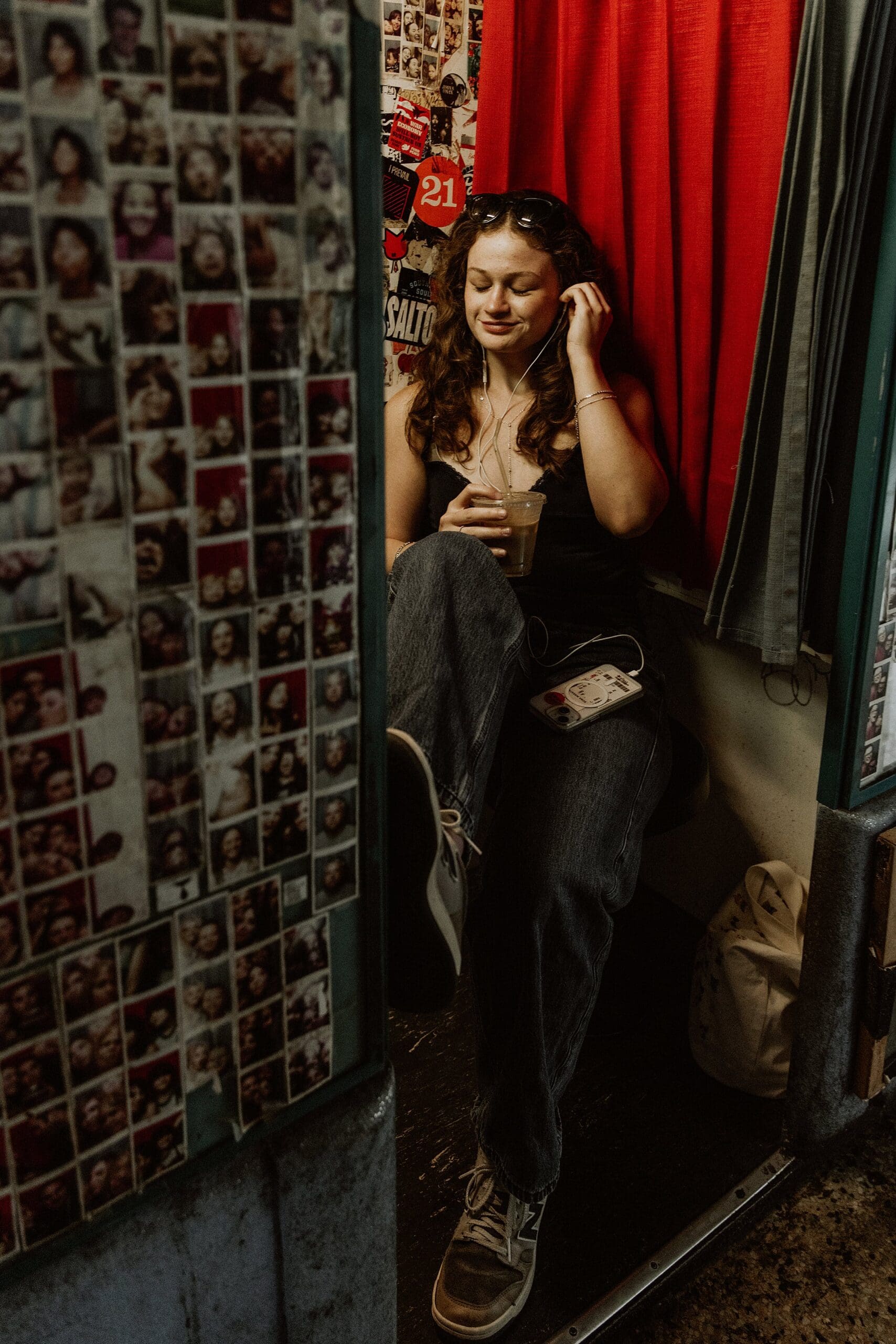 teen girl listening to her headphones inside the old school photo booth at stardust coffee in winter park