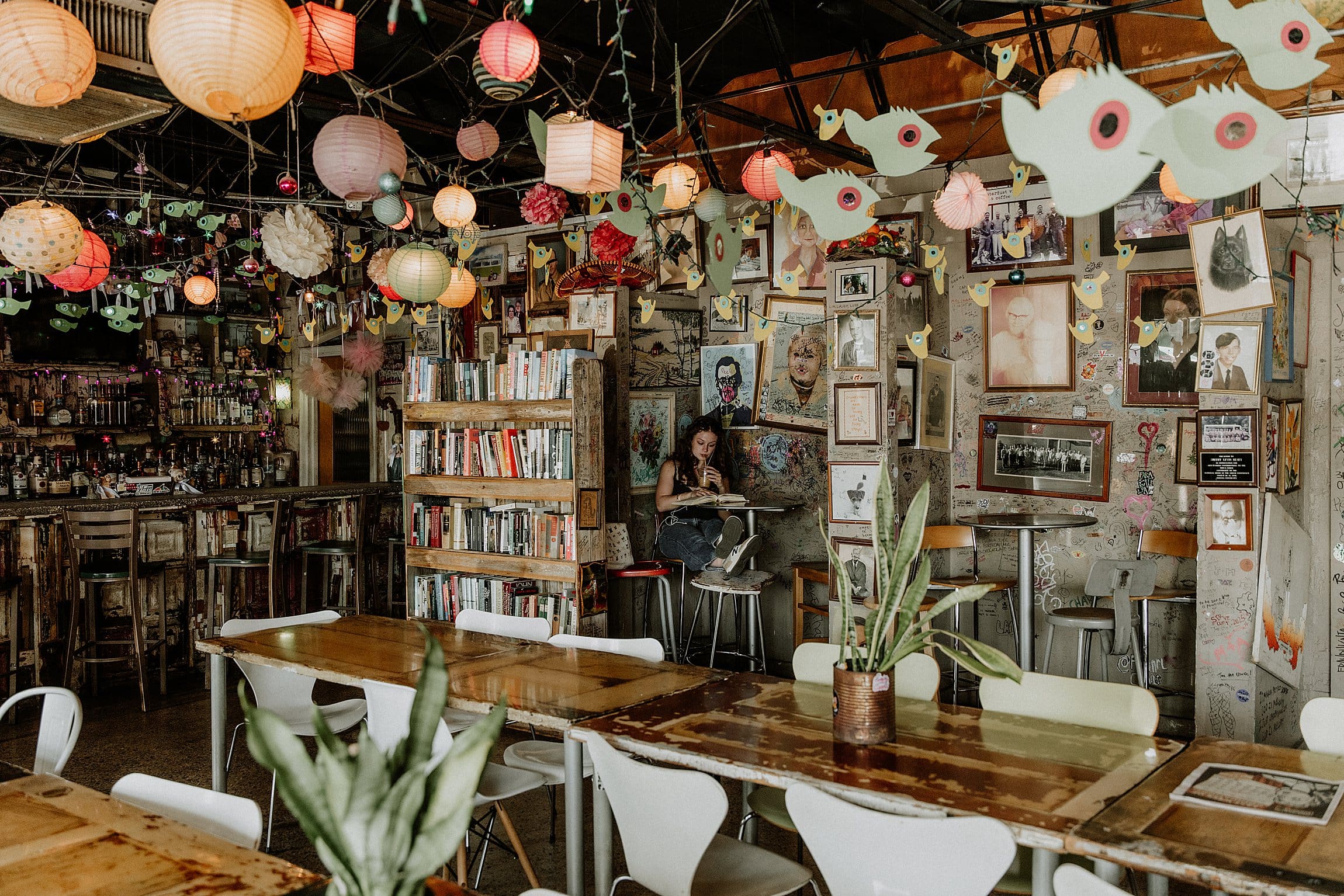 girl reading a book inside one of the nooks at stardust coffee in winter park