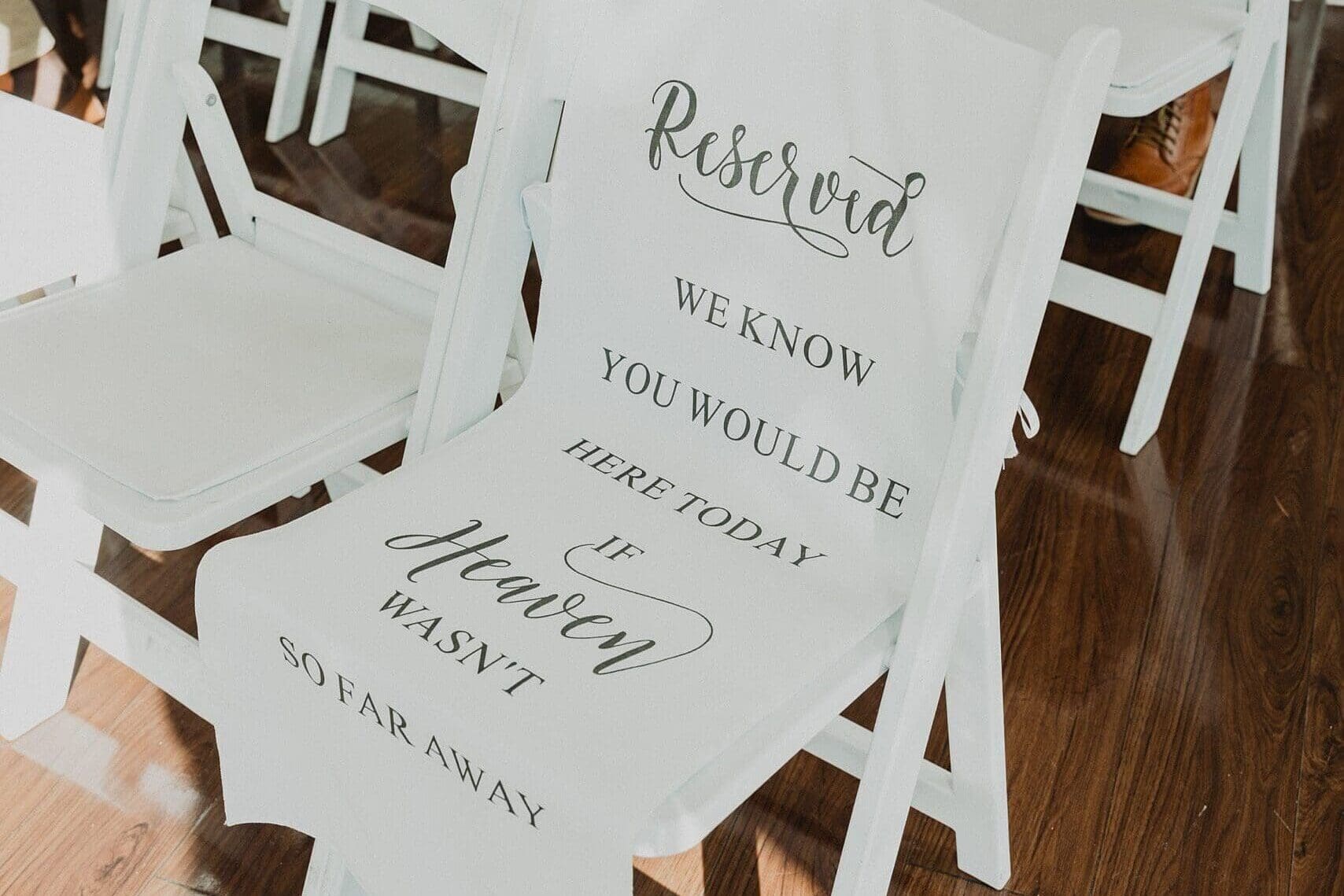 chair with "reserved" sign to honor departed loved ones at a wedding at Lake Mary Events Center in Florida, captured by Gracie May Photography